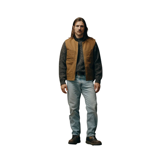 Tan zip-front vest with front patch pockets, worn over a dark sweater