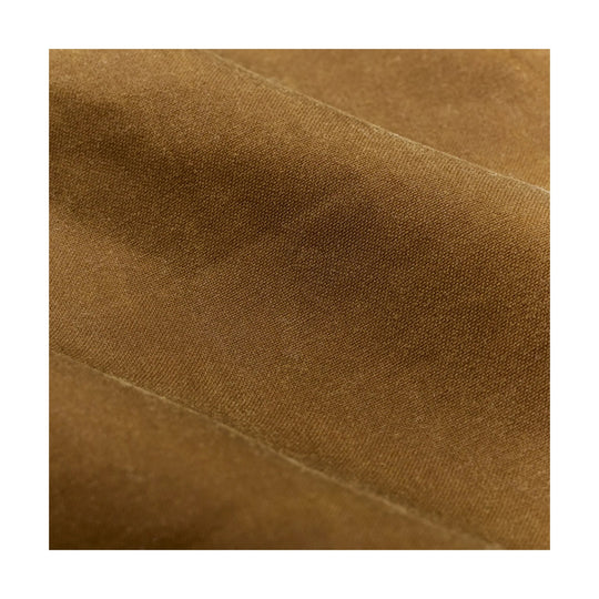 Close-up of brown woven fabric with diagonal folds and texture