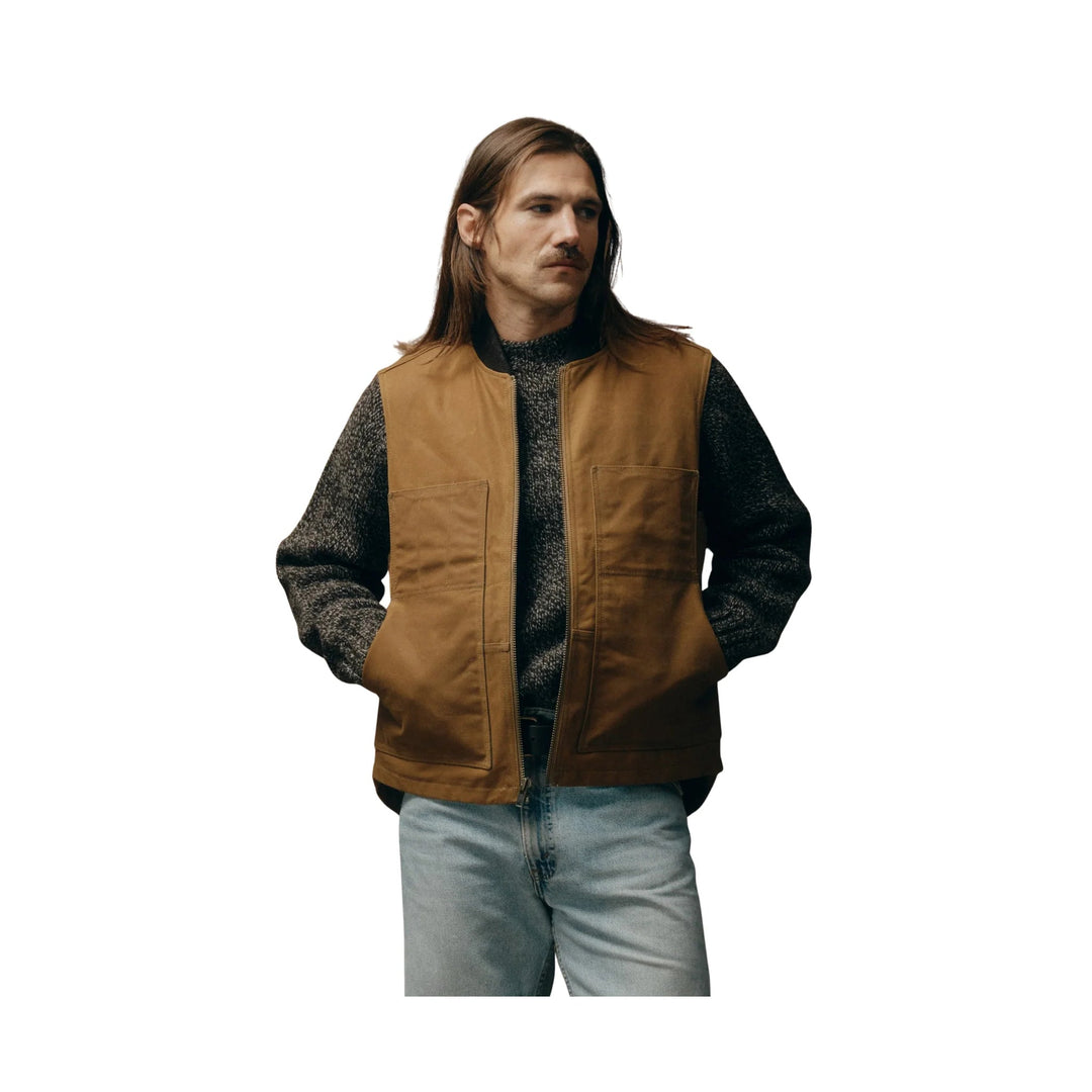 Brown zip-front work vest over a dark knit sweater, shown on a model