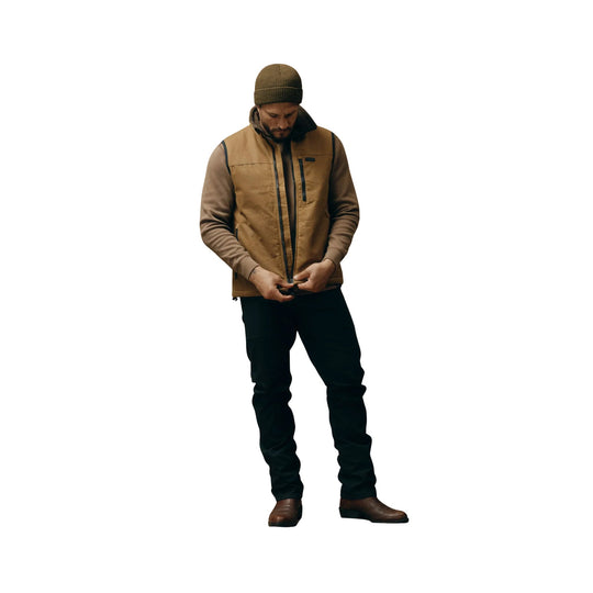 Dark tan zip-front vest over a brown long-sleeve shirt, worn with black pants and brown boots