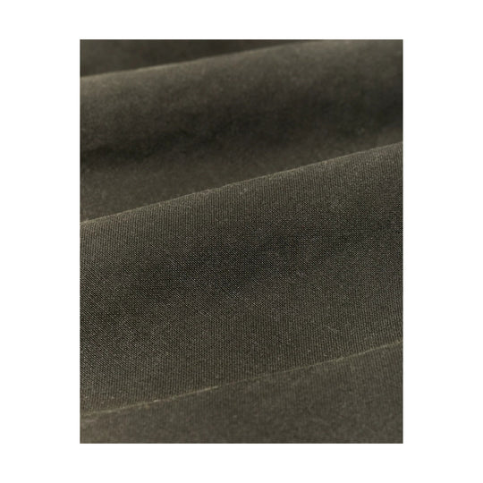 Close-up of dark olive woven fabric with diagonal seam lines