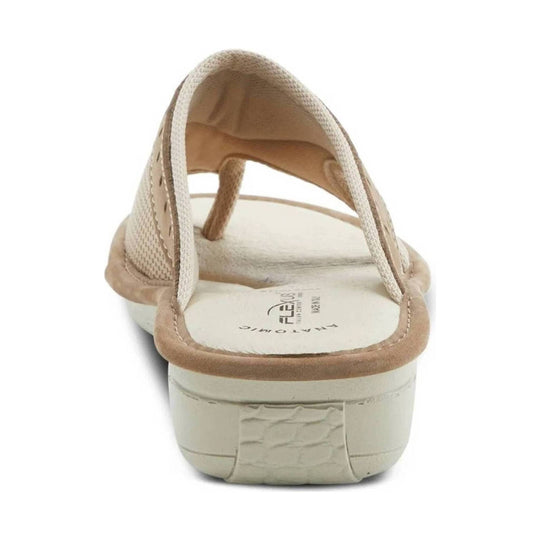 Beige flip-flop sandal with a textured thong strap, cushioned footbed, and low platform sole