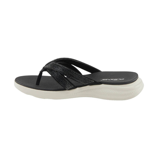 Black thong sandal with rhinestone-embellished straps and a white foam sole