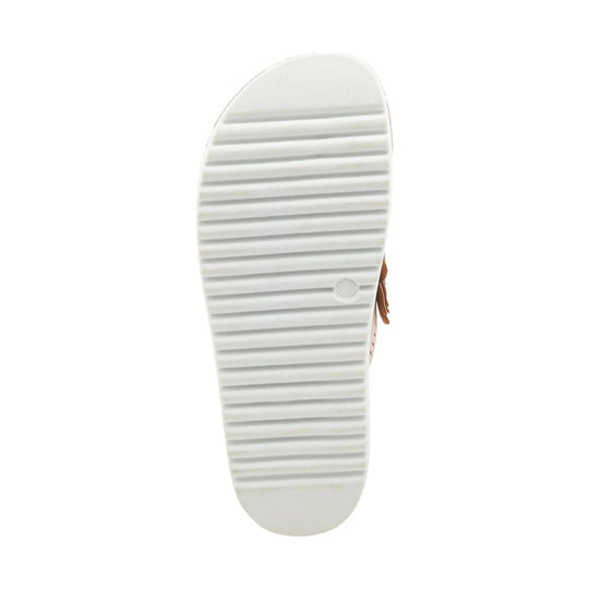 White ribbed sandal sole with a tan strap visible at the side