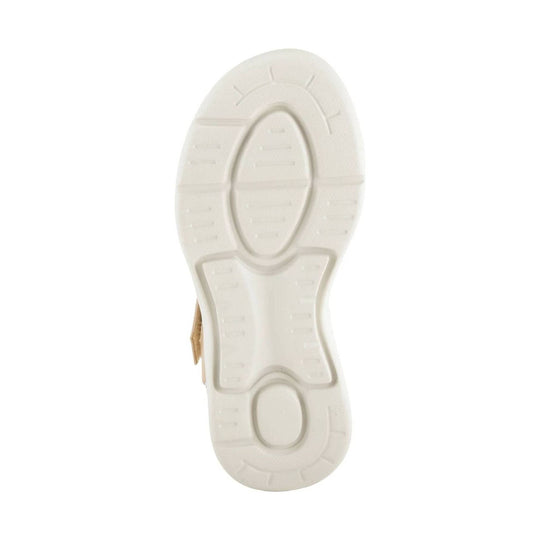 White sandal outsole with molded tread and a small tan upper edge visible on the side
