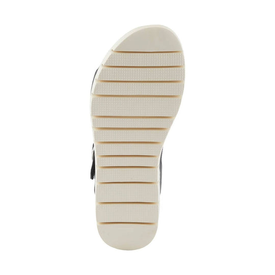Cream lugged sandal sole with wide horizontal tread grooves and rounded heel and toe
