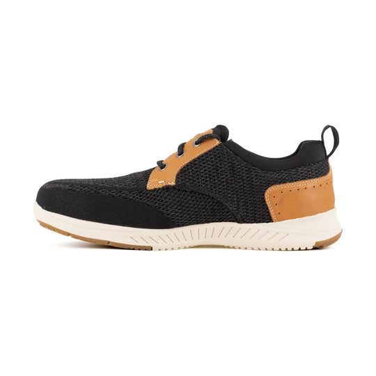 Black knit work shoe with tan leather overlays and a white sole, shown in side view