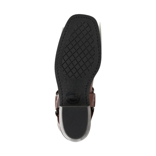 Black boot sole with diamond tread, stitched edge, and brown leather upper visible at the sides