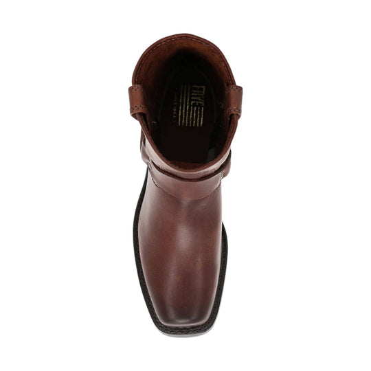 Brown leather ankle boot, top view, with pull tabs and black sole