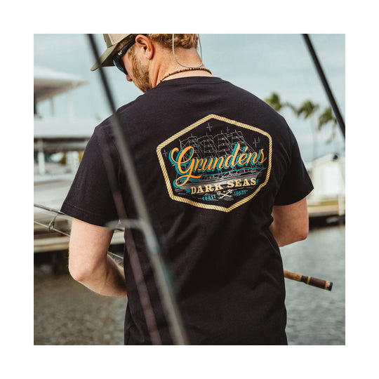 Black short-sleeve T-shirt shown from the back with a large sailboat graphic and printed text