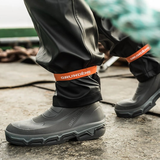 Gray rubber fishing boots with orange GRUNDENS ankle straps