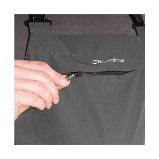 Dark gray fishing bib with buckled shoulder straps and a front zipper pocket