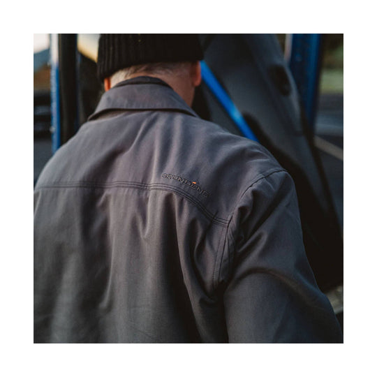 Dark gray work jacket shown from the back with a stand collar and small Grundens logo on the upper back.