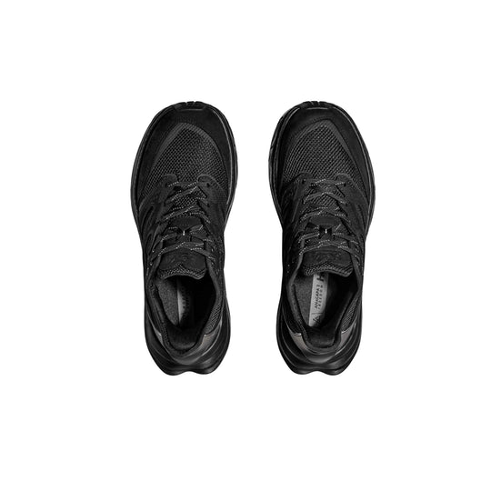 Pair of black trail shoes with mesh uppers, laces, and thick rubber soles, shown from above