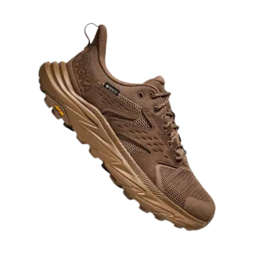 Brown low-top hiking shoe with mesh panels, bungee laces, and a rugged lugged sole