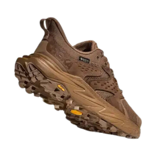Brown low-top hiking shoe with chunky treaded sole, mesh upper, and pull tab