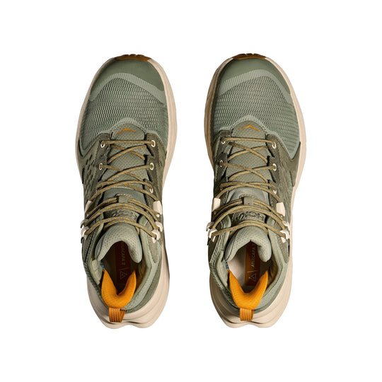 Pair of olive green mid-top hiking shoes with bungee laces and tan soles, seen from above