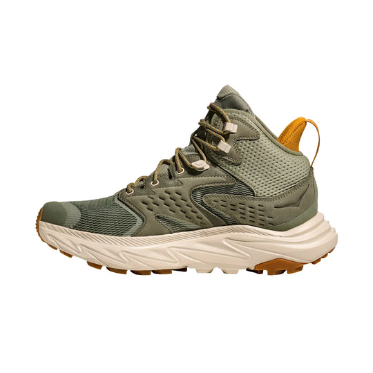 Olive mid-top hiking shoe with a white cushioned sole and orange heel pull tab