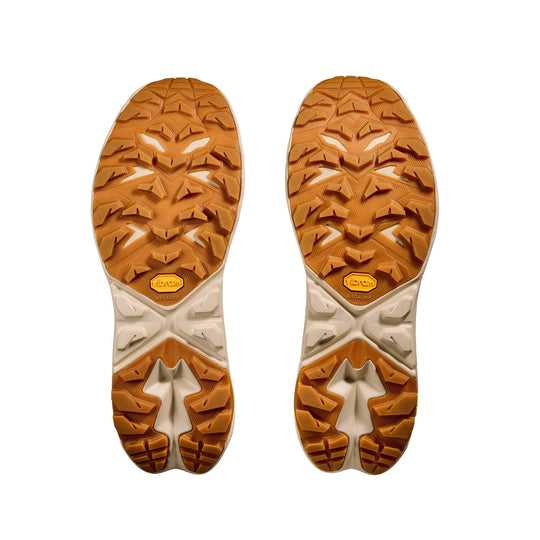 Pair of brown and cream hiking shoe outsoles with deep lugs and Vibram branding