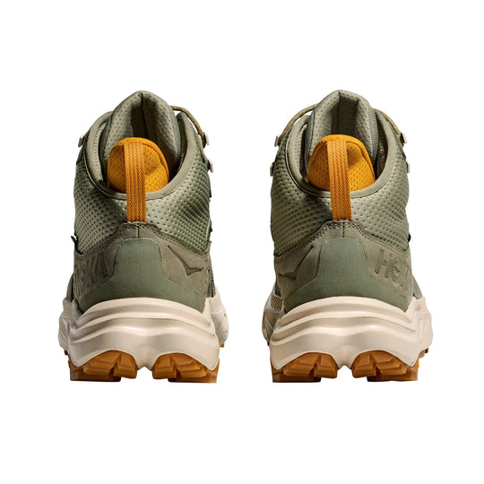 Olive green mid-top hiking shoes with orange heel loops and chunky off-white soles, shown from the back