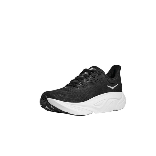 Black running shoe with a thick white foam sole, shown in side view.