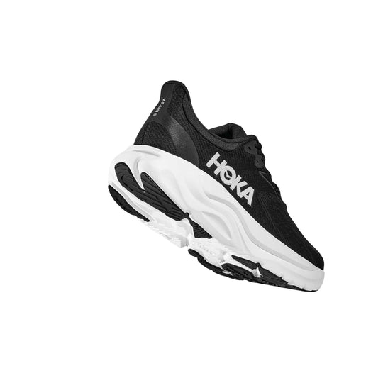 Black and white running shoe with thick cushioned sole and side branding, shown in side view