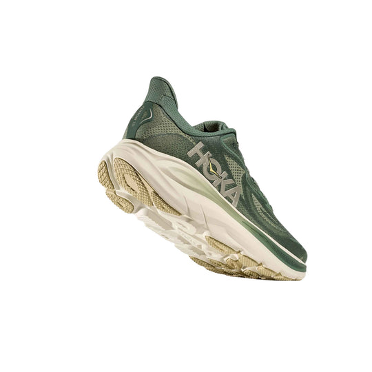 Green knit running shoe with a thick white sole, shown in side and sole view, with visible HOKA branding.