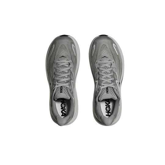 Gray running shoes shown from above with laces and visible HOKA branding on the insoles and tongues.