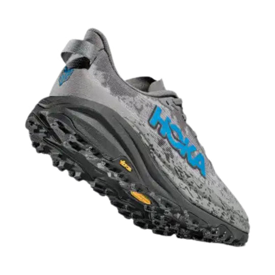 Gray trail running shoe with blue side logo and black lugged outsole, shown in side view