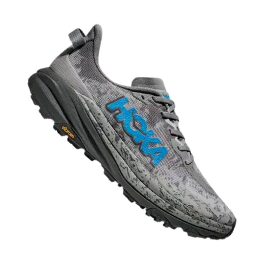 Gray trail running shoe with blue side logo and black lugged sole