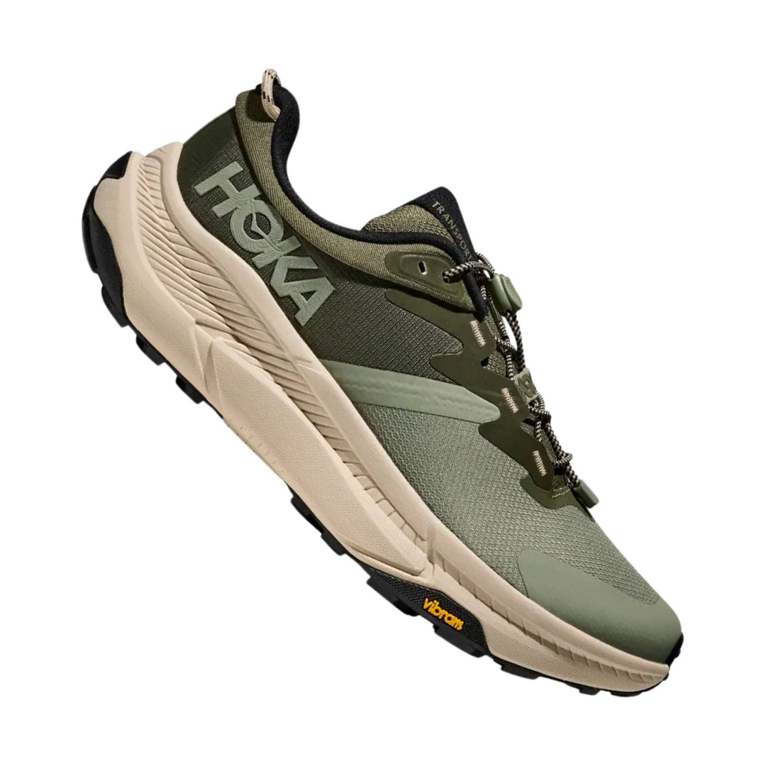 Olive green trail sneaker with tan sole, bungee laces, and black outsole