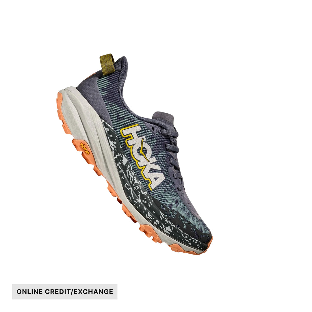 Trail running shoe in gray, black, and orange with side branding and lugged outsole