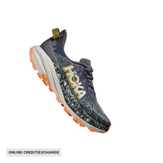 Trail running shoe in gray, black, and orange with side branding and lugged outsole