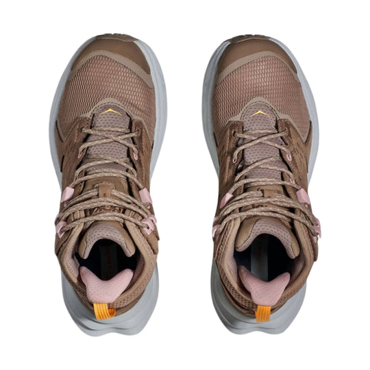 Pair of brown and taupe mid-top hiking shoes with gray soles, mesh uppers, and pink heel tabs