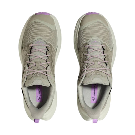 Pair of beige low-top hiking shoes with pink laces, purple heel tabs, and mesh uppers, viewed from above