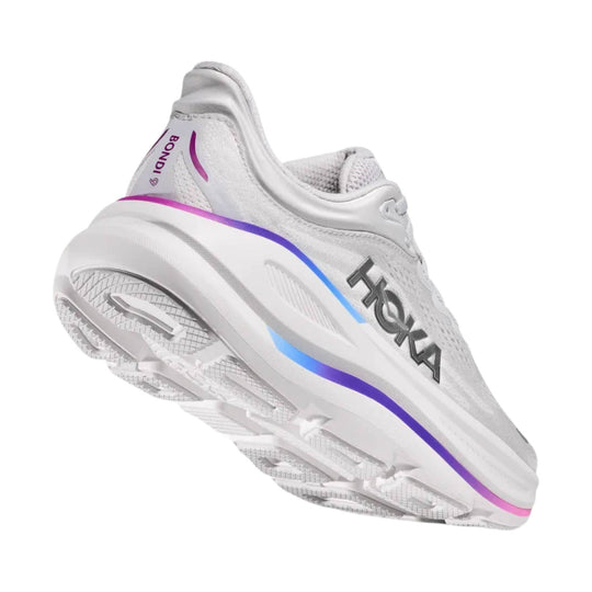 White running shoe with purple and blue side stripe, HOKA logo, and textured outsole shown from the heel side