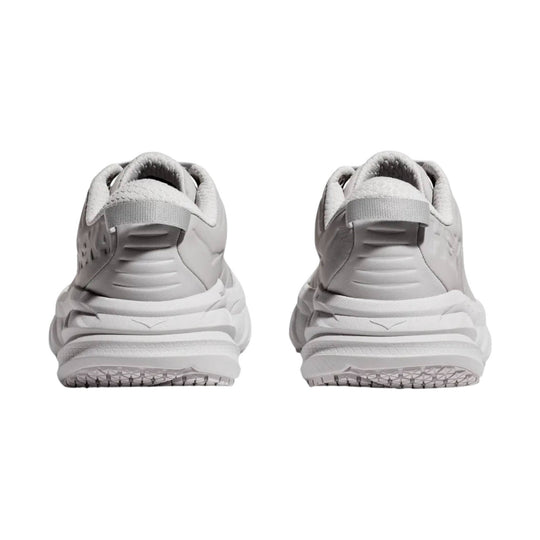 White athletic shoe viewed from the back with a chunky cushioned sole and padded collar