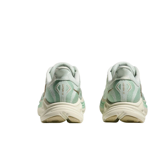 Pair of mint green and cream running shoes shown from the back with chunky cushioned soles