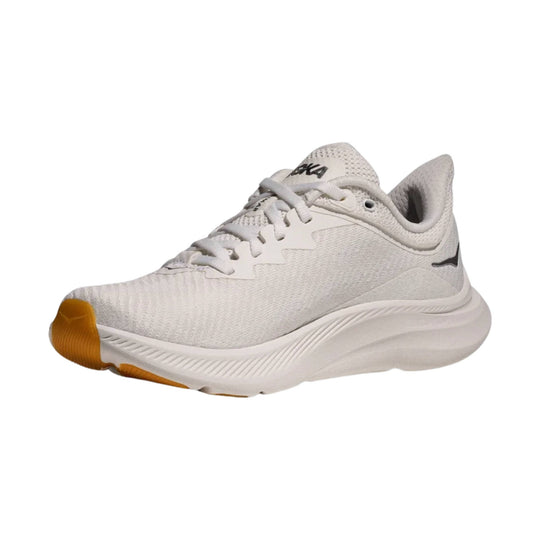 White low-top athletic shoe with knit upper, lace-up closure, and orange outsole accents