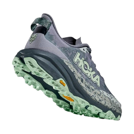 Gray trail running shoe with mint-green lugged sole and HOKA logo