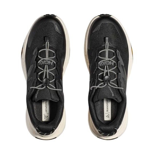 Pair of black trail shoes with bungee laces and cream midsoles, shown from above