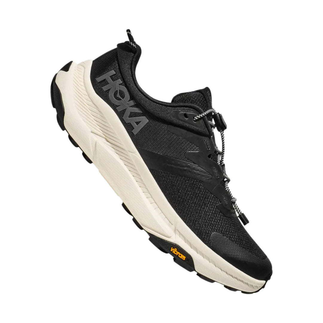 Black athletic trail shoe with a thick white midsole, bungee laces, and side HOKA branding