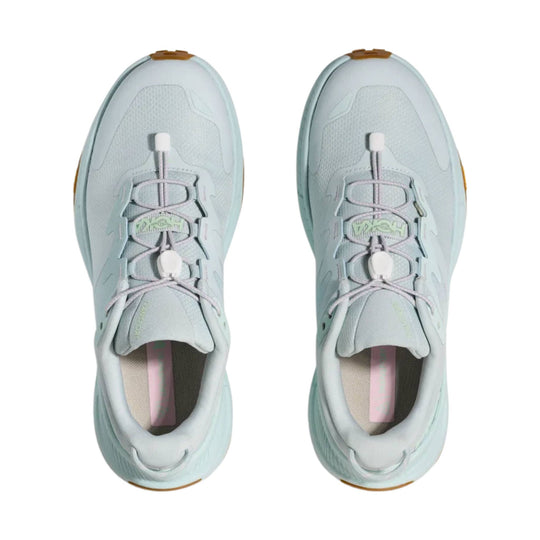 Pair of light gray low-top trail shoes with bungee laces and chunky soles, shown from above
