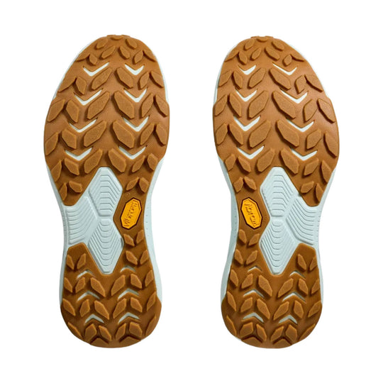 Pair of brown lugged shoe outsoles with white midfoot panels and yellow Vibram badges