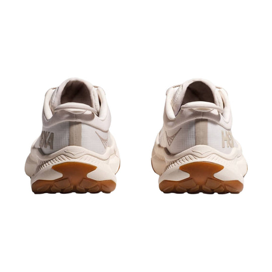 Pair of cream and beige athletic sneakers shown from the back, with gum soles and visible HOKA branding