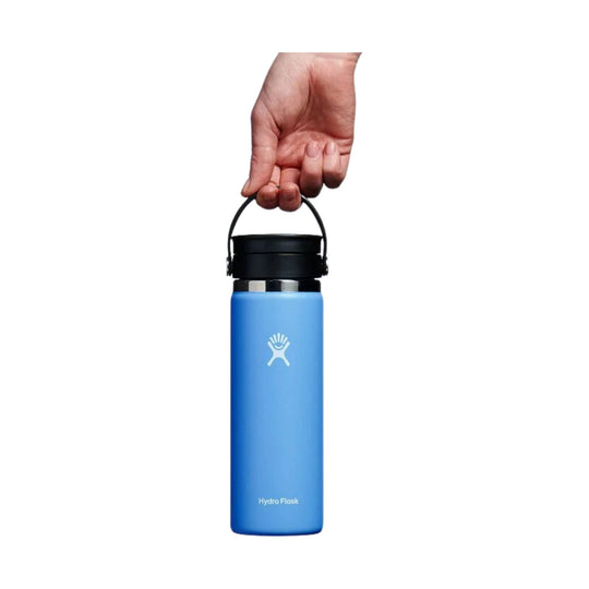 Blue insulated bottle with black carry handle and lid, shown being held by the loop