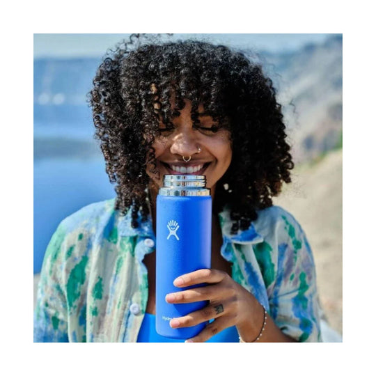 Blue insulated water bottle with a white logo and stainless steel lid