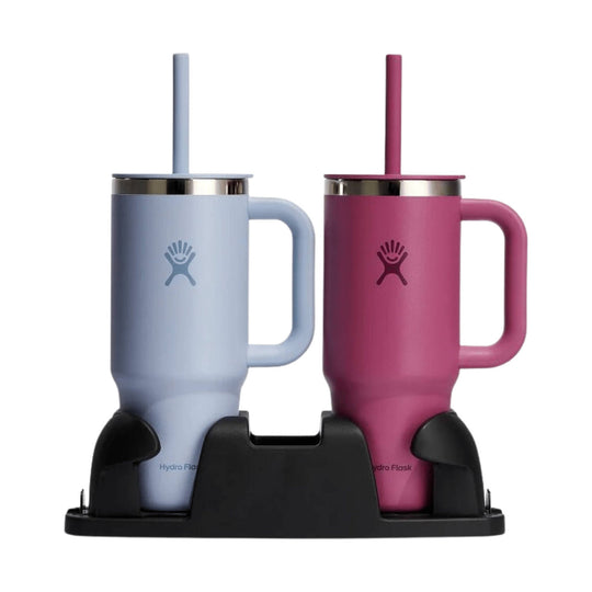 Two handled insulated tumblers in light blue and pink on a black carrier, each with a straw lid