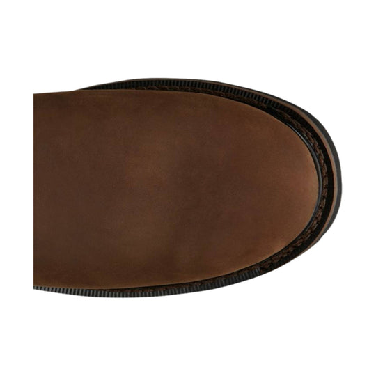 Brown leather boot toe with black welt and stitched sole edge