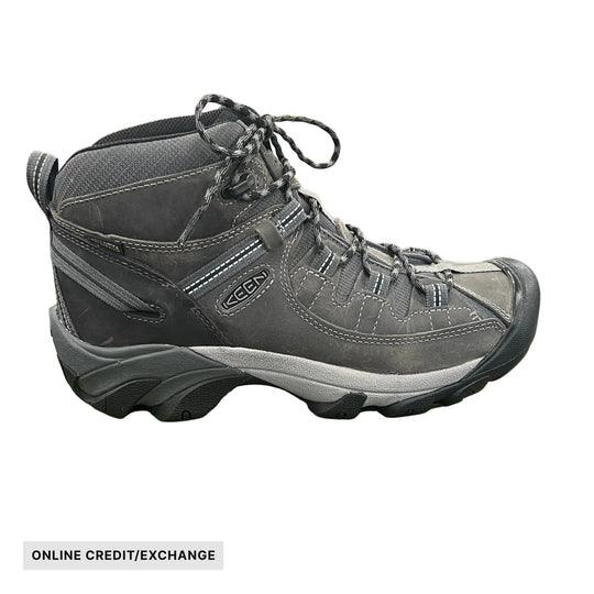 Gray and black mid-height hiking boot with bungee laces and a white sole, shown in side view